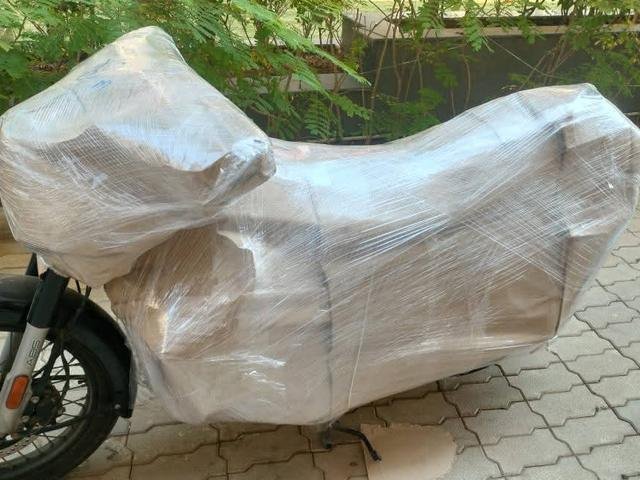 Motorbike wrapped in film and paper cover for safe transport