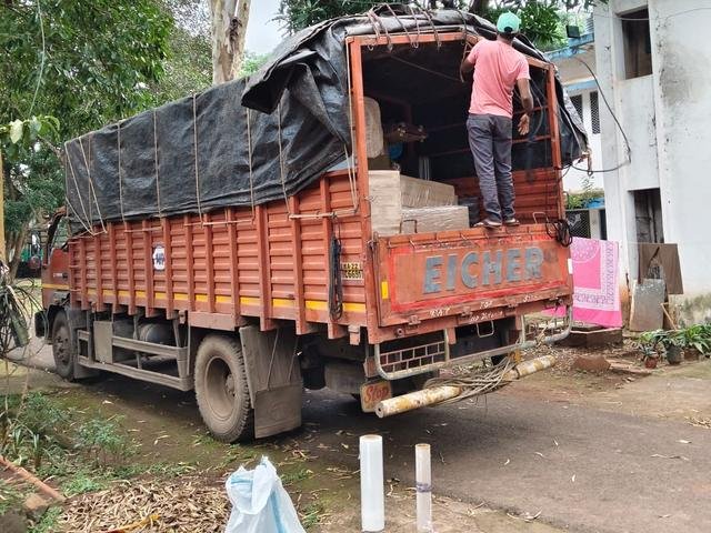 Loaded truck covered with a tarpaulin, ready for a long-distance move