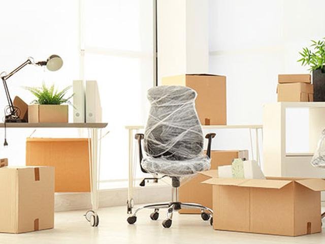 Office desks, chairs and boxes packed for an office move