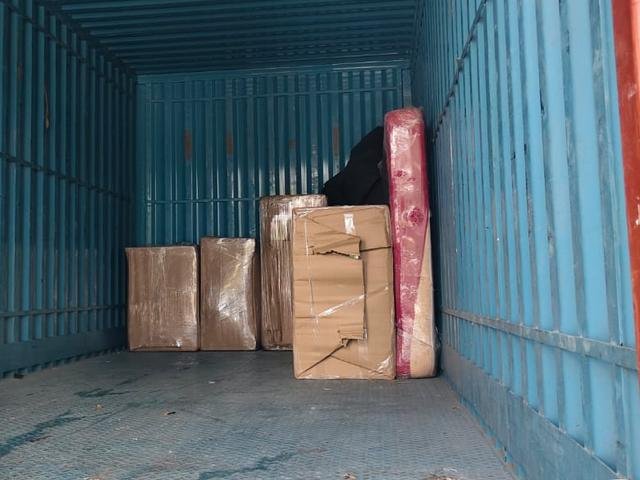 Closed container truck with wrapped boxes and a mattress loaded inside